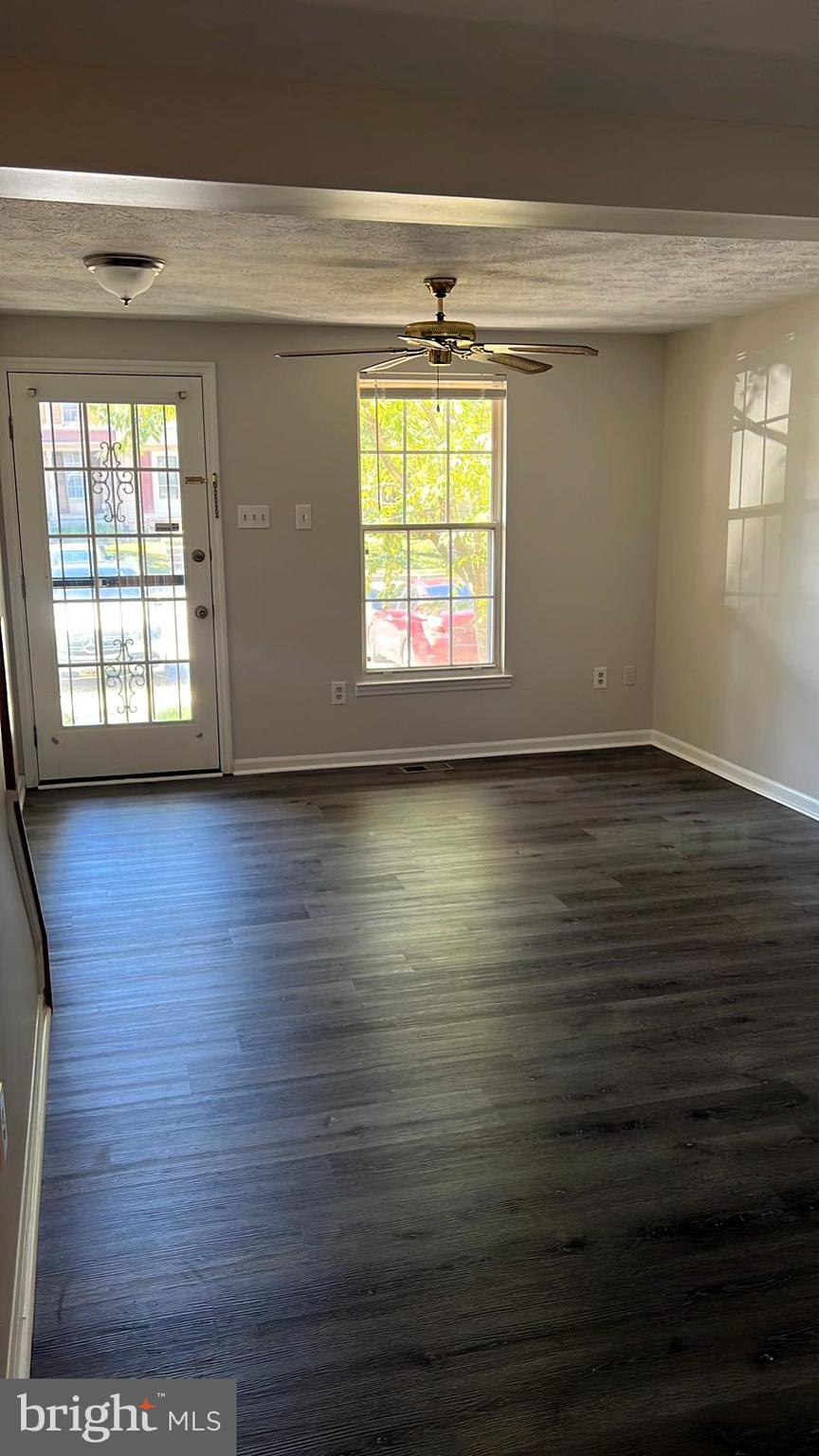 2243 Riding Crop Way Windsor Mill, MD 21244 - Photo 7 of 17 an empty room with wooden floor and windows