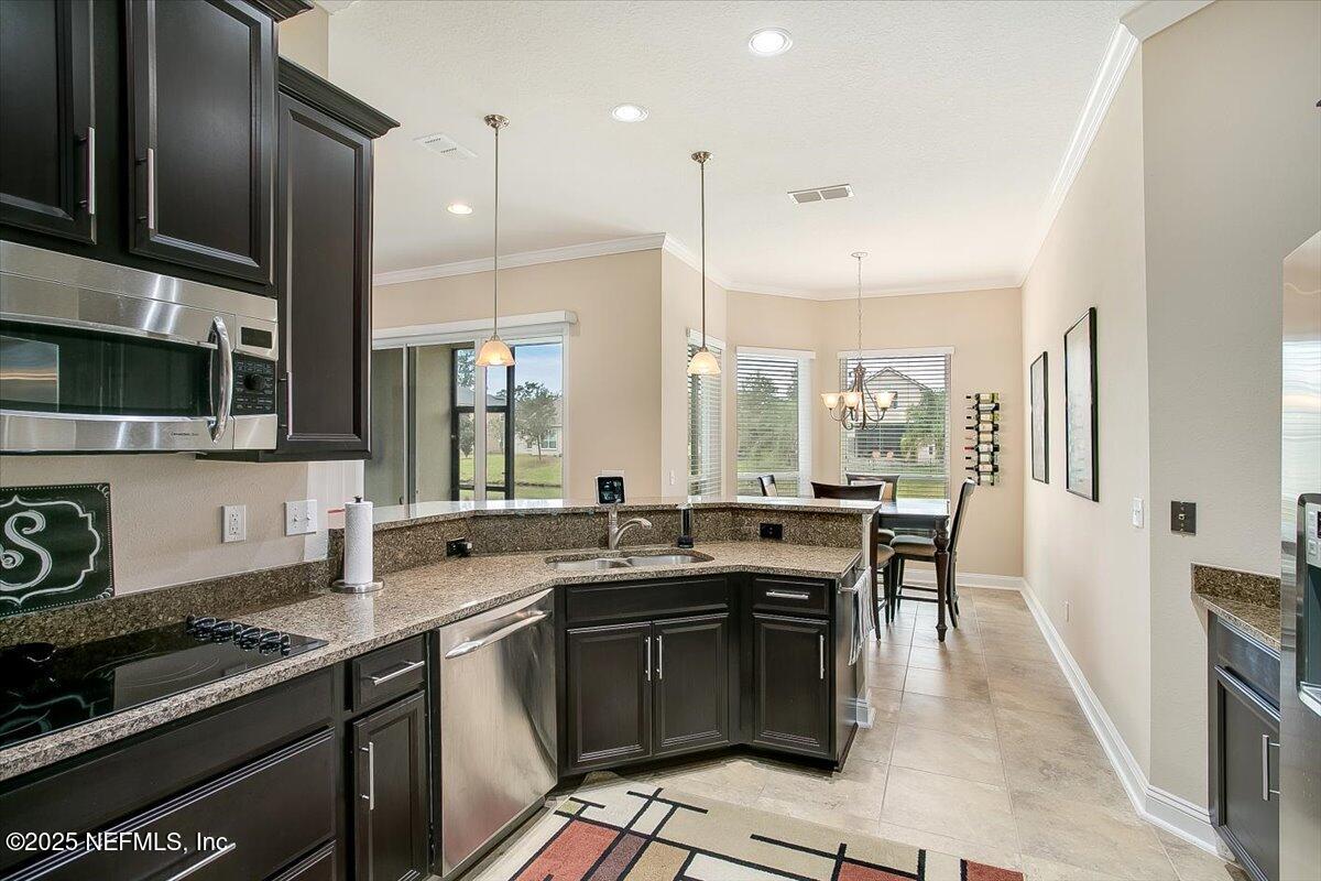 11780 Paddock Gates Drive Jacksonville, FL 32223 - Photo 15 of 39 a kitchen with granite countertop a sink stove and cabinets
