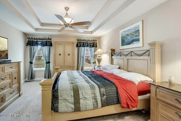 a bedroom with a large bed closet and flat tv screen