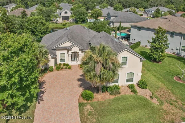 a spacious bedroom with a bed and a chandelier