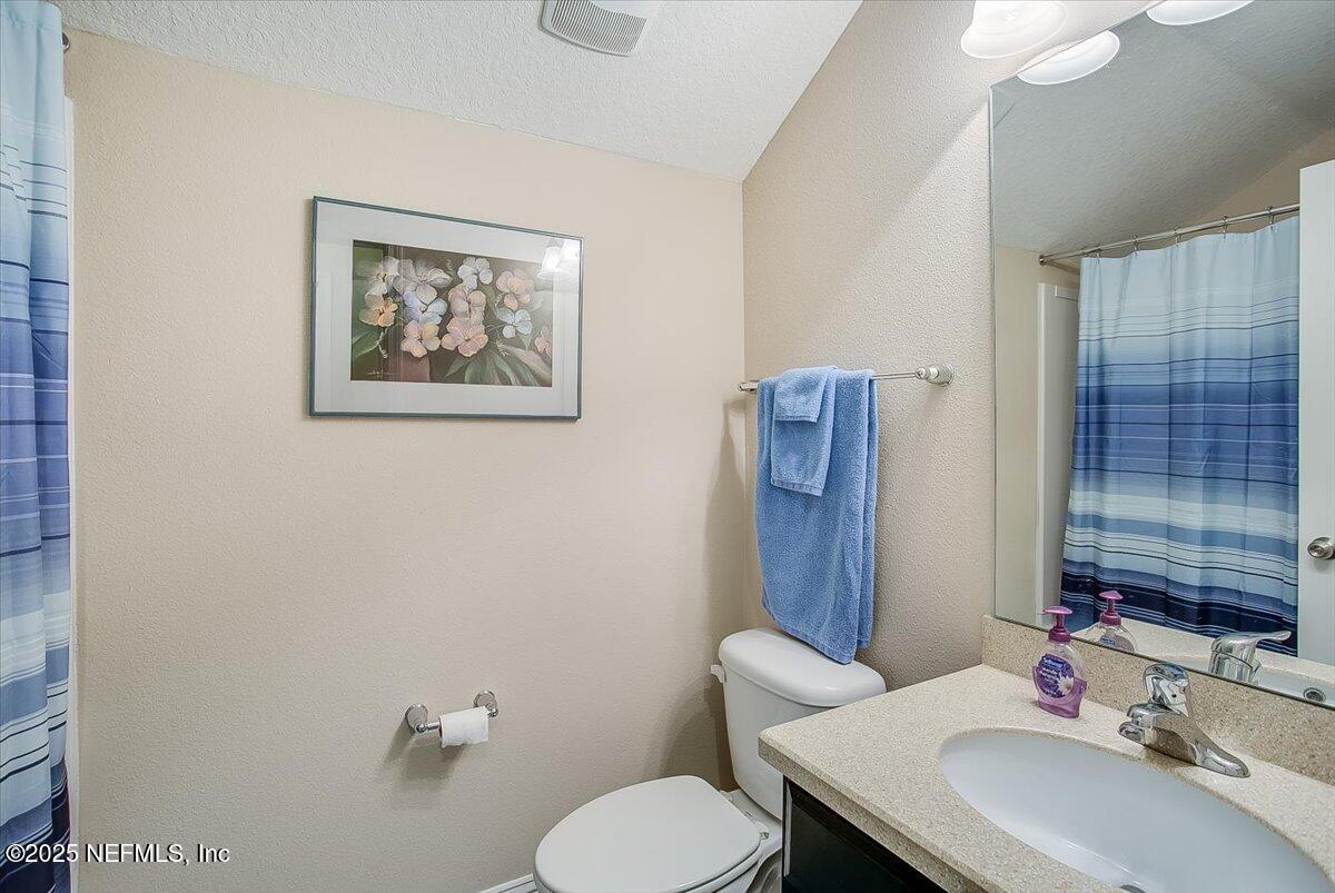 11780 Paddock Gates Drive Jacksonville, FL 32223 - Photo 28 of 39 a bathroom with a toilet sink and mirror