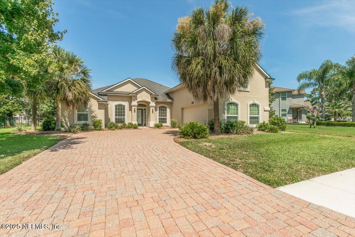 11780 Paddock Gates Drive Jacksonville, FL 32223 - Photo 3 of 39 a front view of a house with a garden