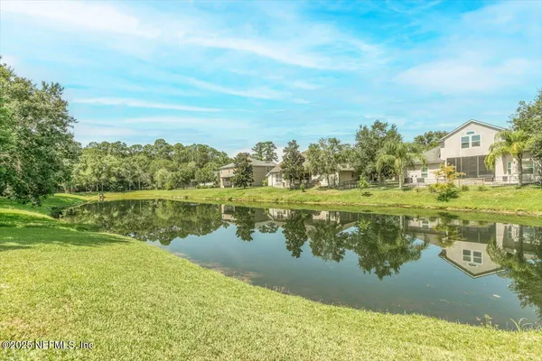 an aerial view of a house with garden space and street view