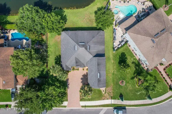 an aerial view of a house with a garden and yard