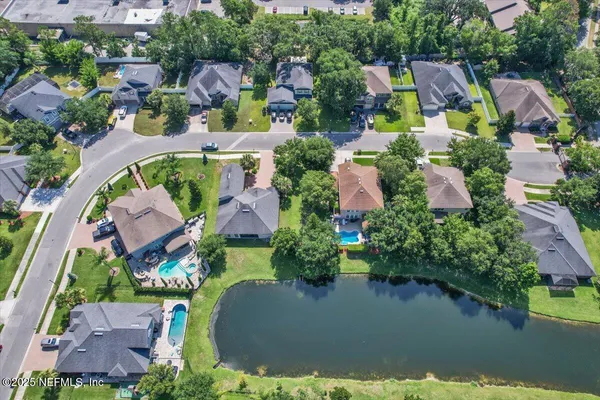 an aerial view of a house with swimming pool and outdoor space