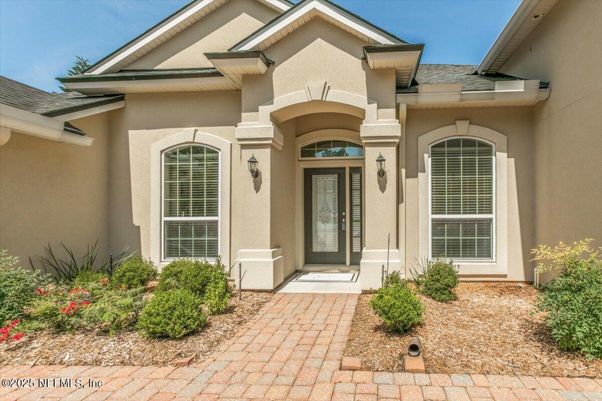 11780 Paddock Gates Drive Jacksonville, FL 32223 - Photo 4 of 39 a front view of a house with garden