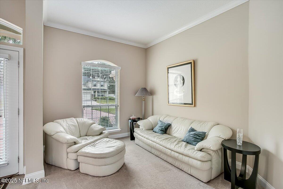 11780 Paddock Gates Drive Jacksonville, FL 32223 - Photo 6 of 39 a living room with furniture and a large window