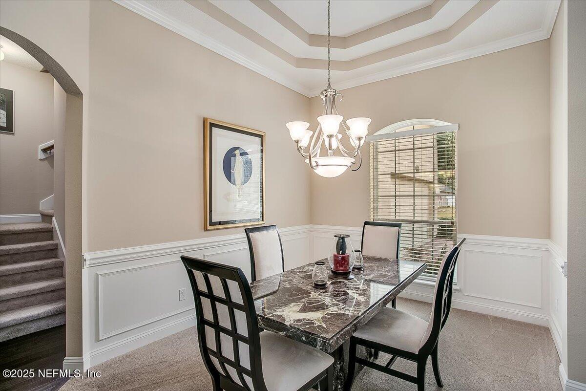 11780 Paddock Gates Drive Jacksonville, FL 32223 - Photo 8 of 39 a view of a dining room with furniture wooden floor and chandelier
