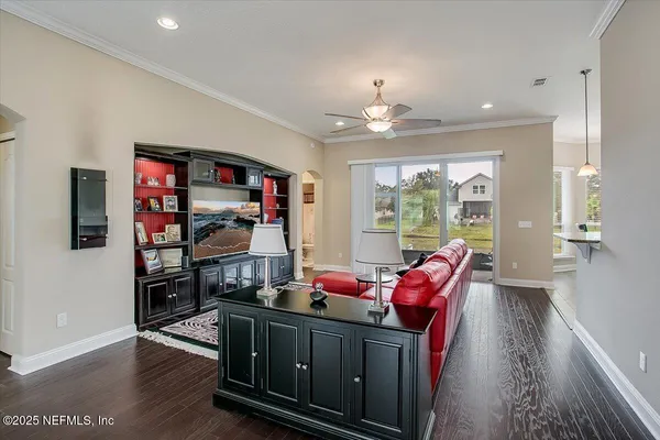 a living room with furniture fireplace and wooden floor