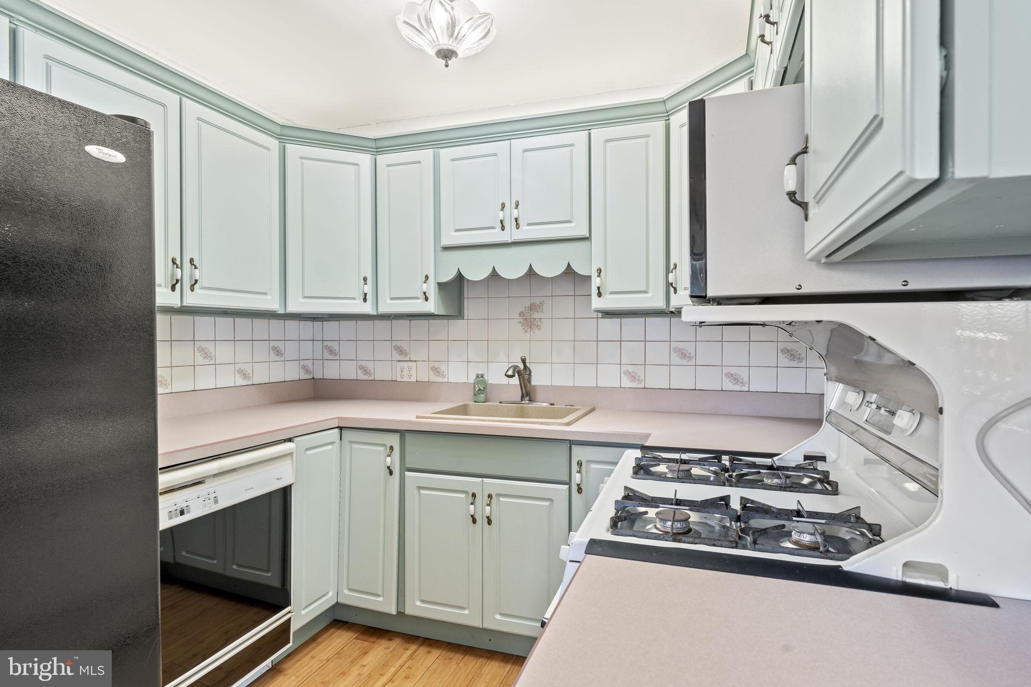 12419 Balston Road Philadelphia, PA 19154 - Photo 12 of 33 a kitchen with white cabinets stainless steel appliances and sink