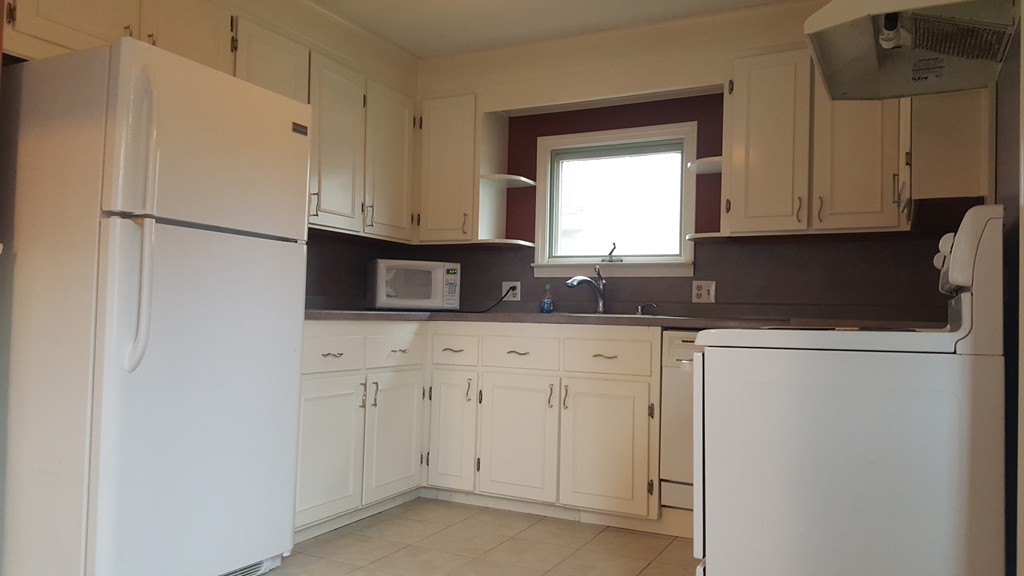 48 Agnes Street Springfield, MA 01118 - Photo 11 of 23 a kitchen with stainless steel appliances granite countertop white refrigerator sink and cabinets