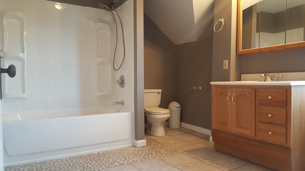 48 Agnes Street Springfield, MA 01118 - Photo 16 of 23 a bathroom with a granite countertop toilet a sink and bathtub