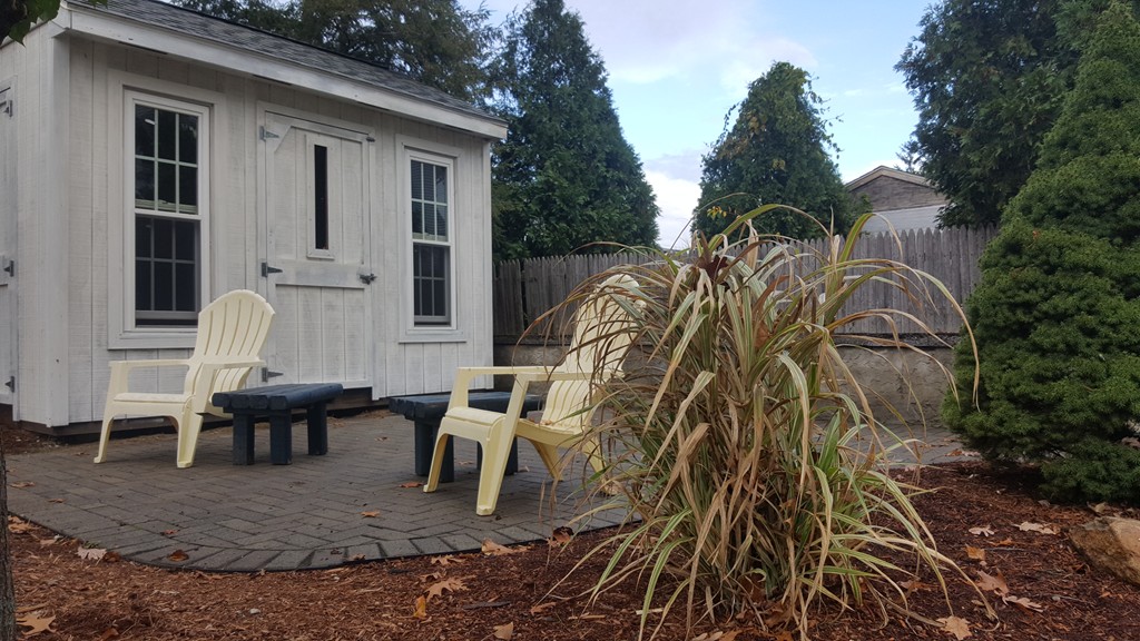 48 Agnes Street Springfield, MA 01118 - Photo 4 of 23 a view of a patio with table and chairs with wooden floor and fence