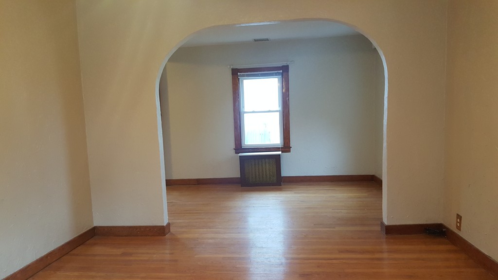 48 Agnes Street Springfield, MA 01118 - Photo 10 of 23 a view of an empty room with wooden floor and a window