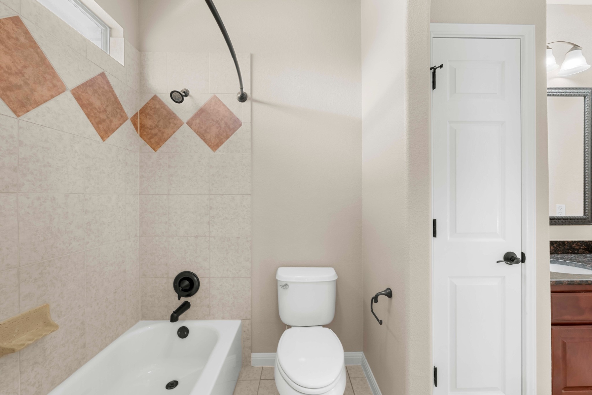 3903 Remington Road Cedar Park, TX 78613 - Photo 24 of 29 A well-appointed bathroom offers a clean tub-shower combination, providing a functional and inviting space.