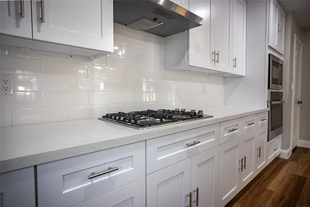 a view of staircase and kitchen with wooden floor and kitchen view