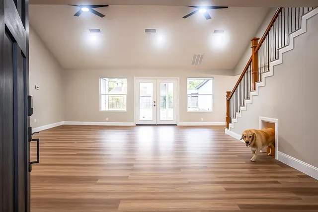 a view of a hallway view with wooden floor and staircase