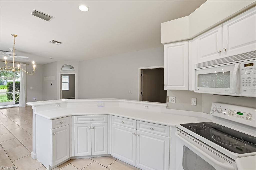 12517 Stone Valley Loop Fort Myers, FL 33913 - Photo 15 of 36 a kitchen with white cabinets appliances and a window