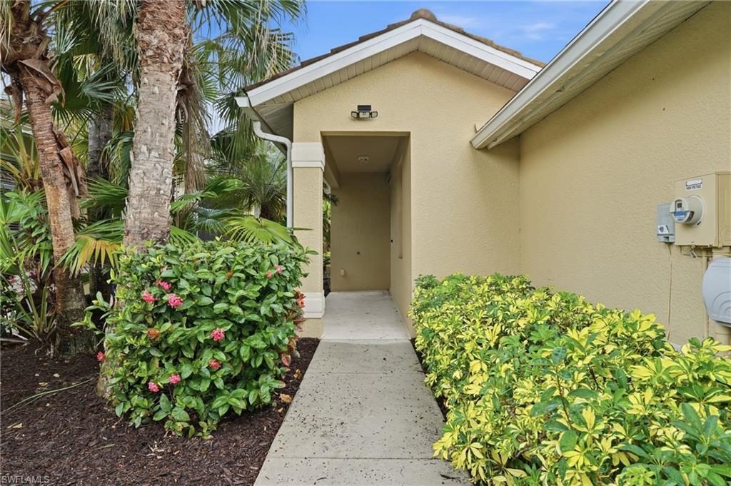 12517 Stone Valley Loop Fort Myers, FL 33913 - Photo 2 of 36 a front view of a house with garden