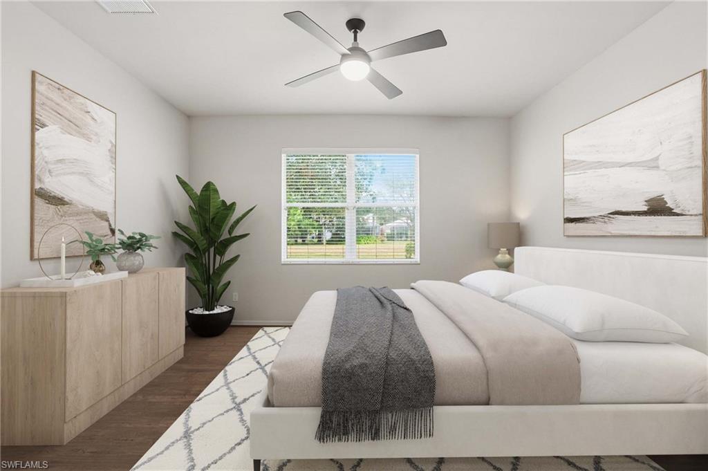 12517 Stone Valley Loop Fort Myers, FL 33913 - Photo 23 of 36 a bedroom with a large bed and a potted plant