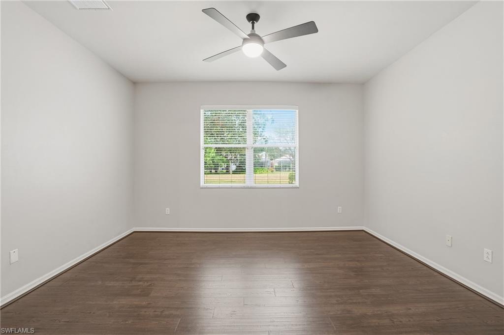 12517 Stone Valley Loop Fort Myers, FL 33913 - Photo 24 of 36 an empty room with wooden floor and windows