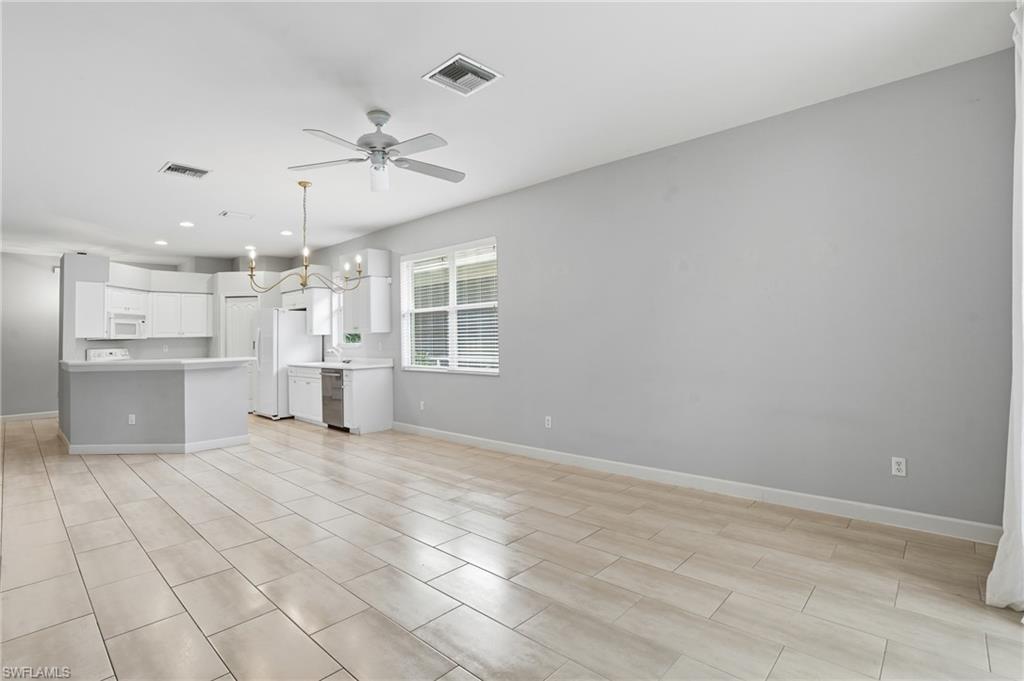 12517 Stone Valley Loop Fort Myers, FL 33913 - Photo 10 of 36 a view of a kitchen with wooden cabinet and a kitchen space with a sink