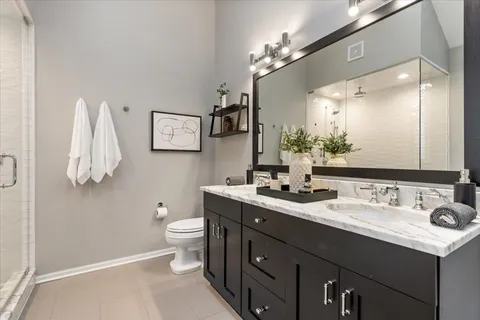 a bathroom with a tub sink and mirror