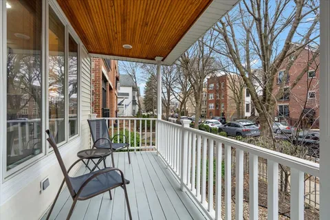 a view of a chairs on deck with wooden floor and fence