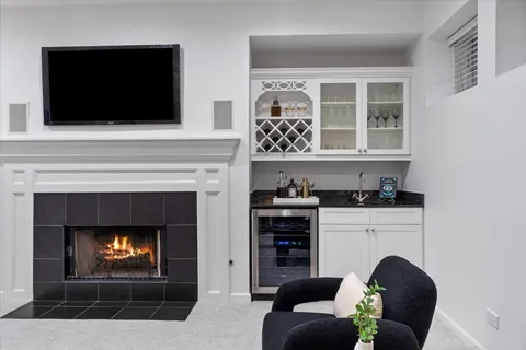 a bathroom with a white sink a toilet and shower curtain
