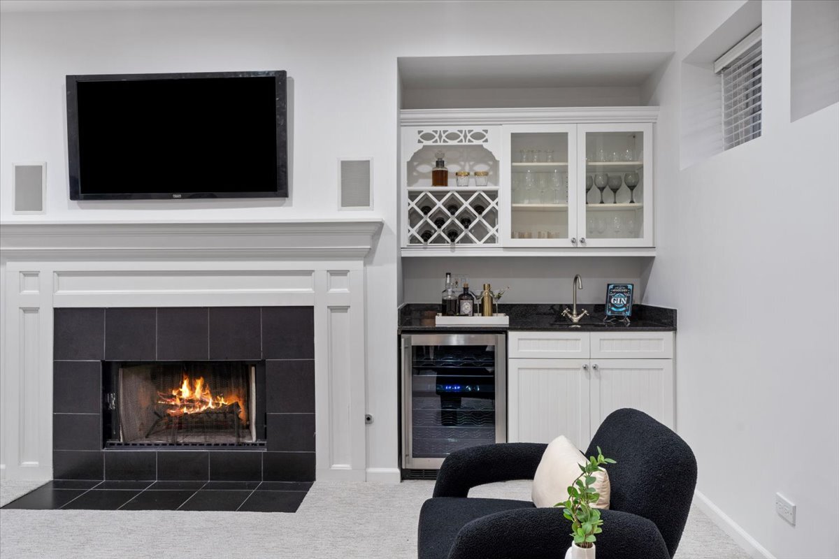 1937 West Melrose Street Chicago, IL 60657 - Photo 29 of 41 a living room with furniture a flat screen tv and a fireplace