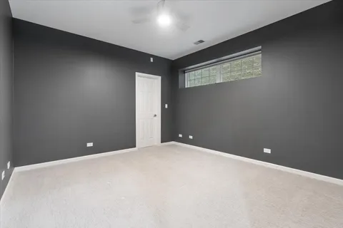 a roof deck with chairs and wooden floor