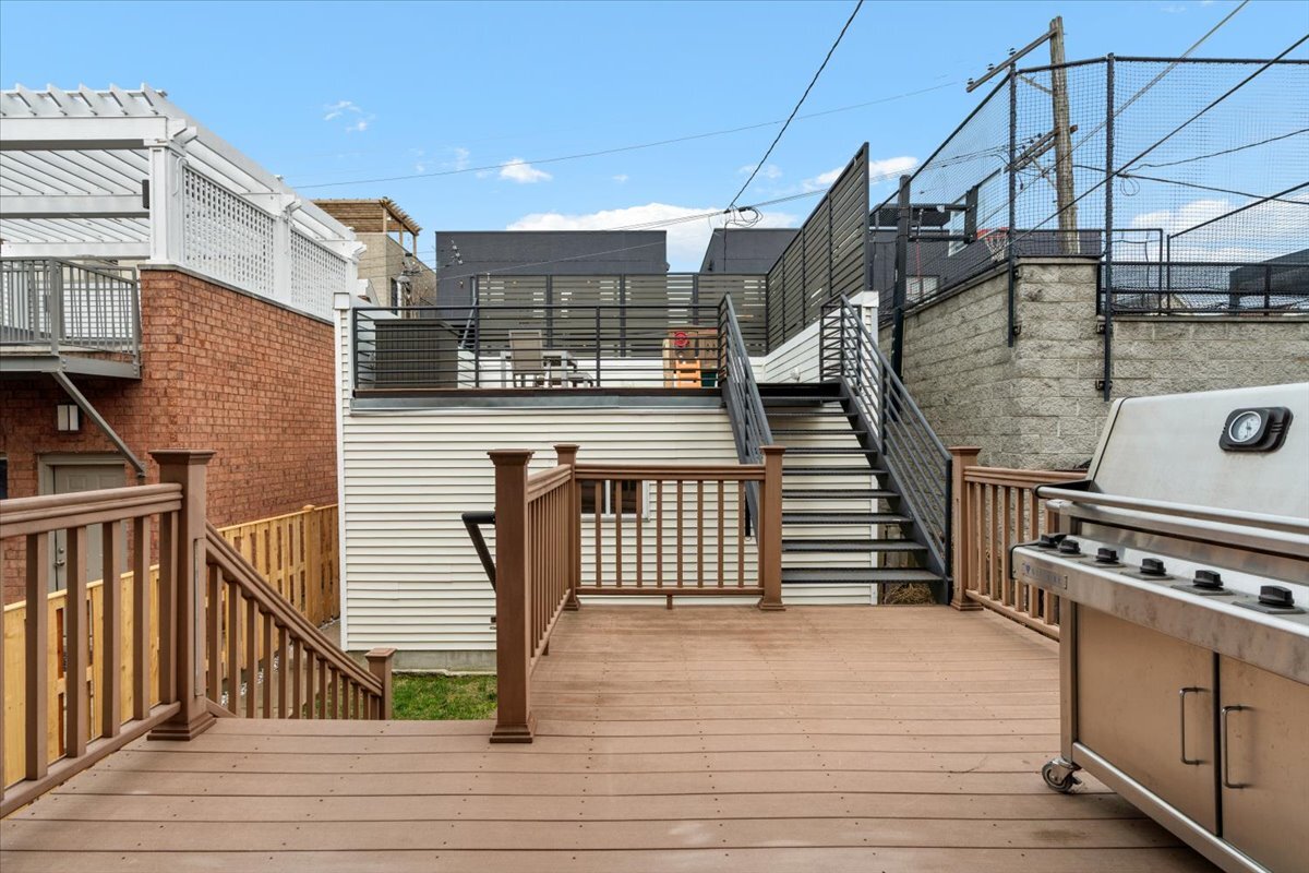 1937 West Melrose Street Chicago, IL 60657 - Photo 33 of 41 a view of a roof deck with wooden floor and fence