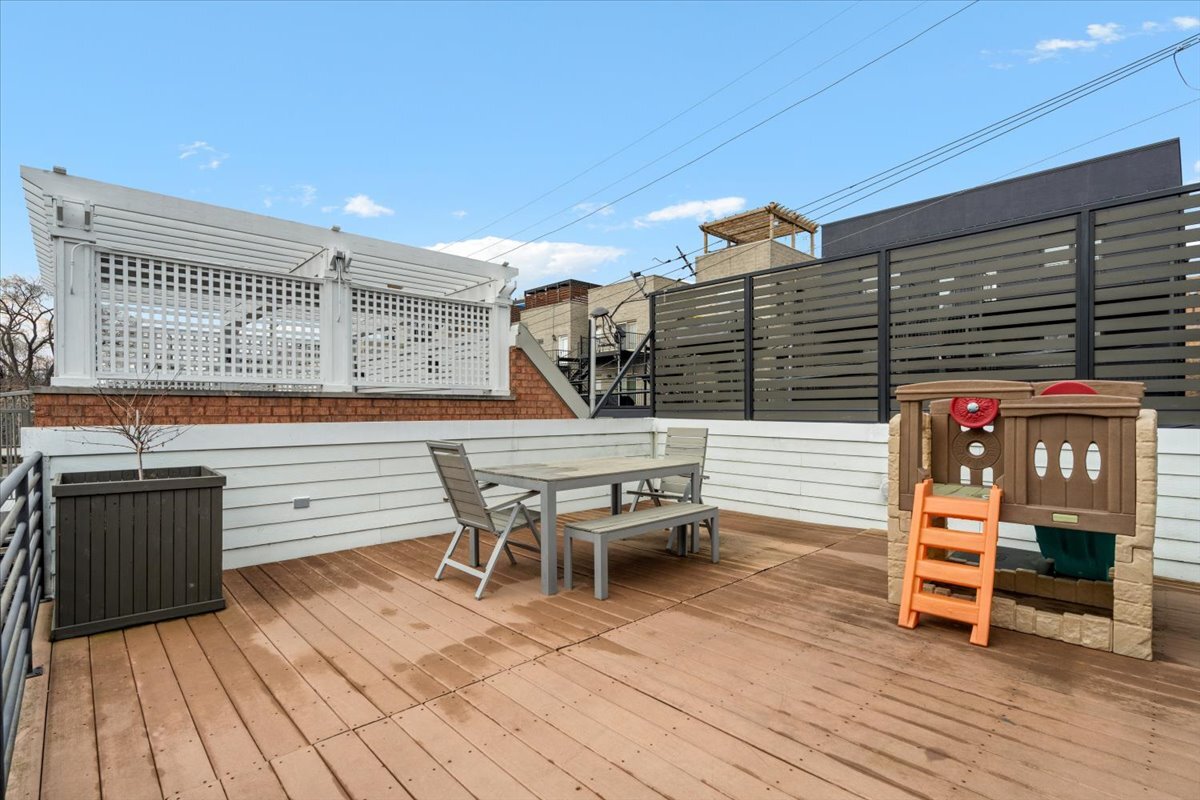 1937 West Melrose Street Chicago, IL 60657 - Photo 35 of 41 a roof deck with chairs and wooden floor