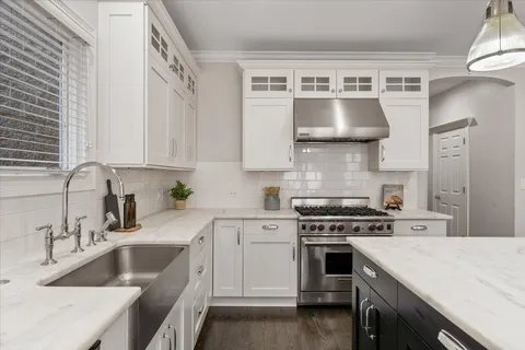a large kitchen with a table and chairs