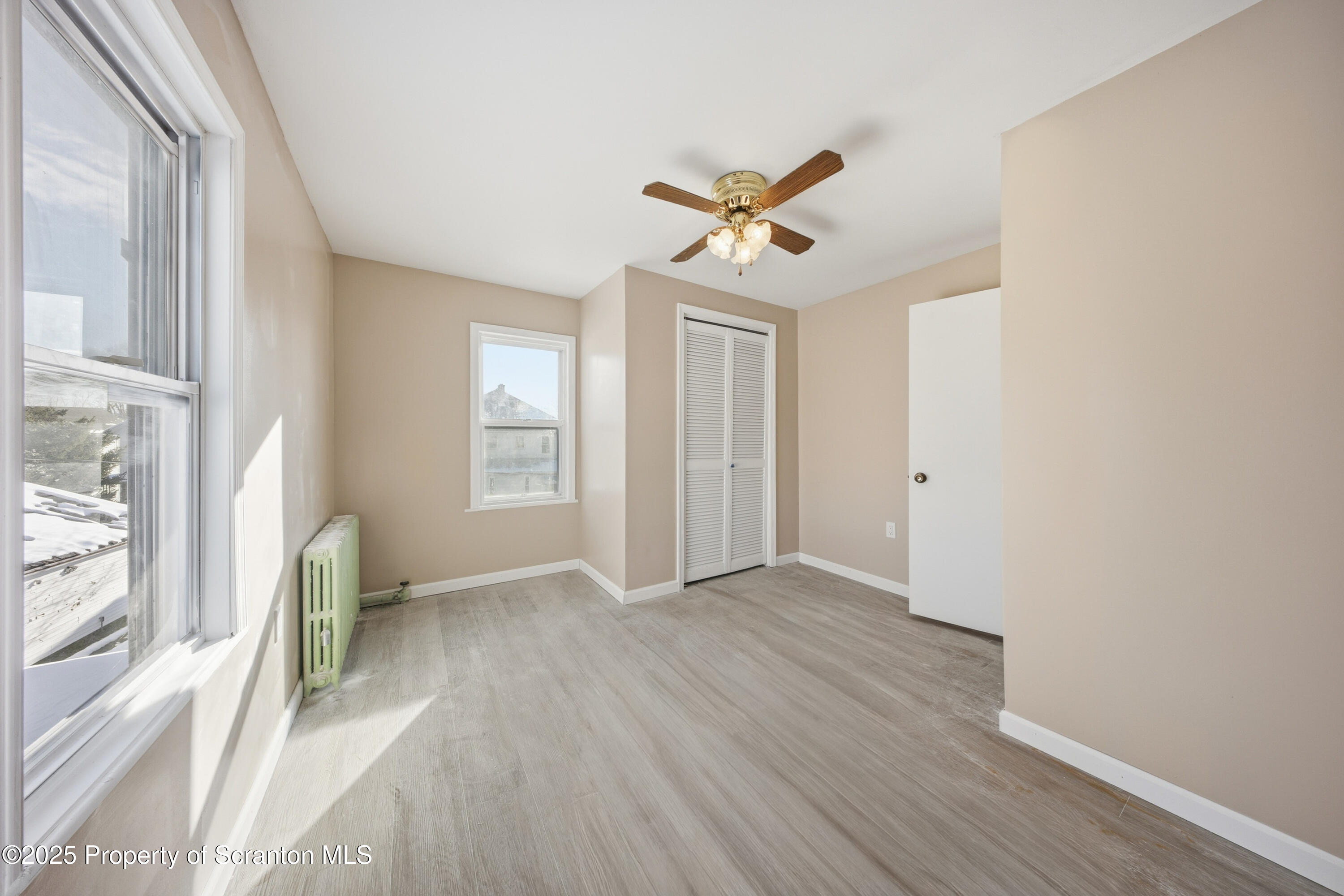 612 Philo Street Scranton, PA 18508 - Photo 14 of 22 a view of empty room with wooden floor and fan