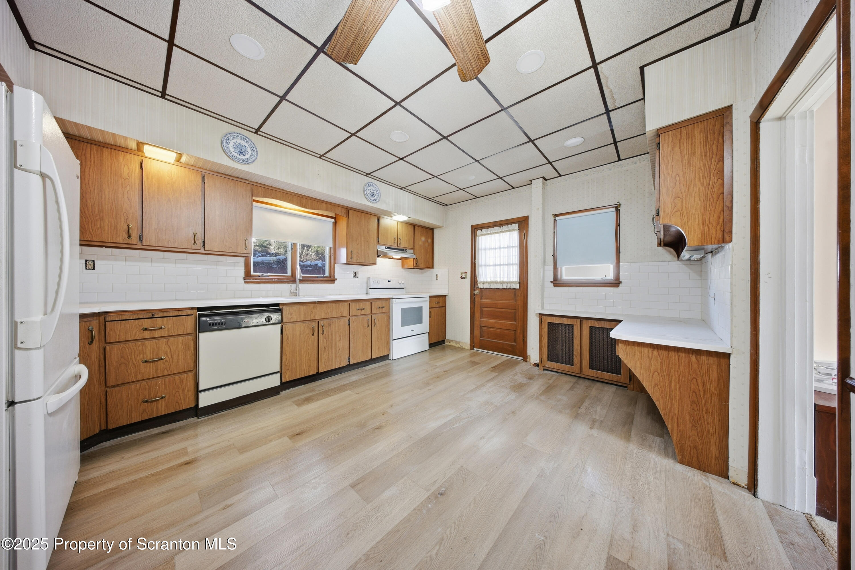 612 Philo Street Scranton, PA 18508 - Photo 6 of 22 a kitchen with stainless steel appliances granite countertop a sink cabinets and wooden floor
