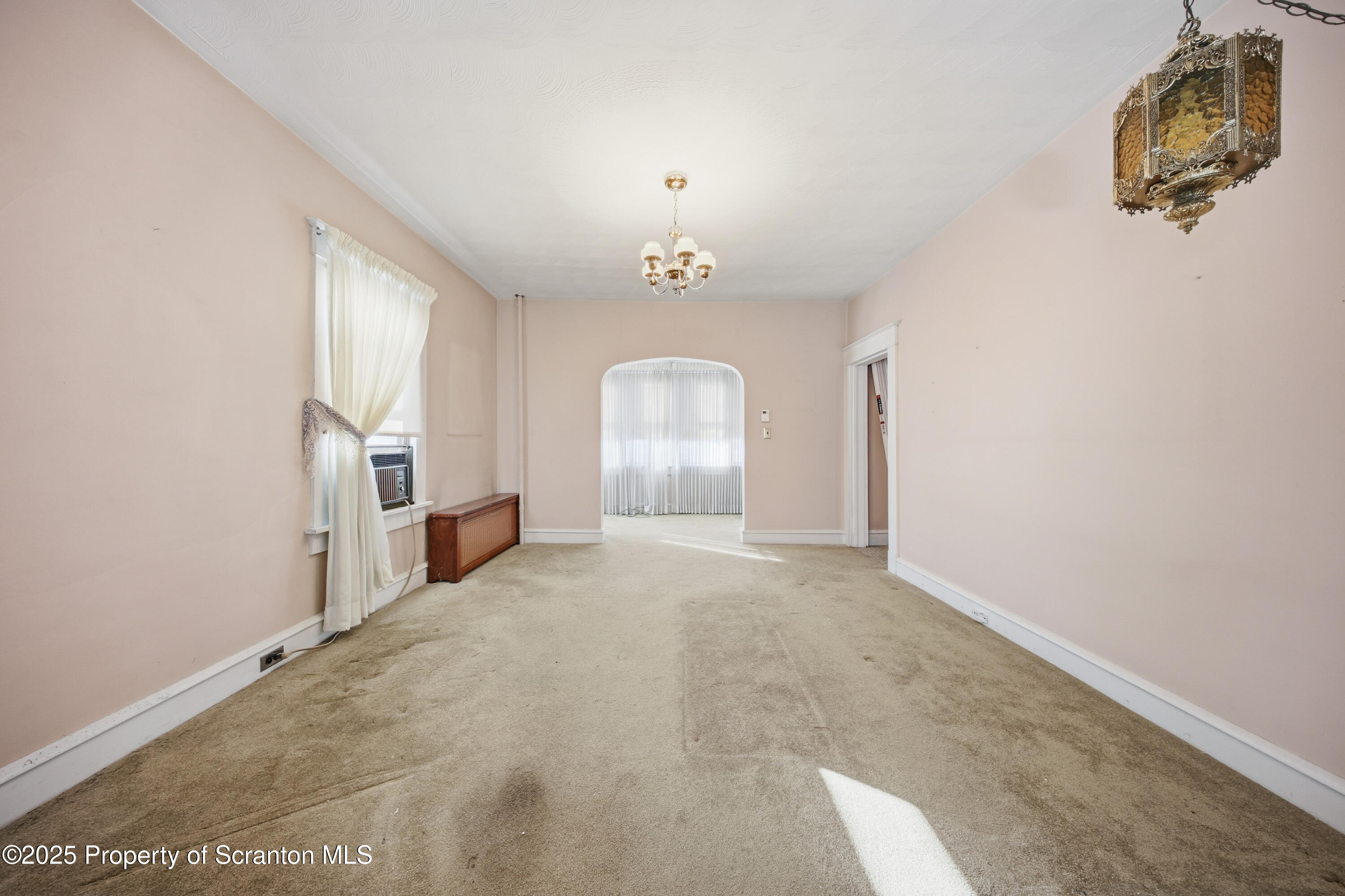 612 Philo Street Scranton, PA 18508 - Photo 10 of 22 an empty room with windows and chandelier