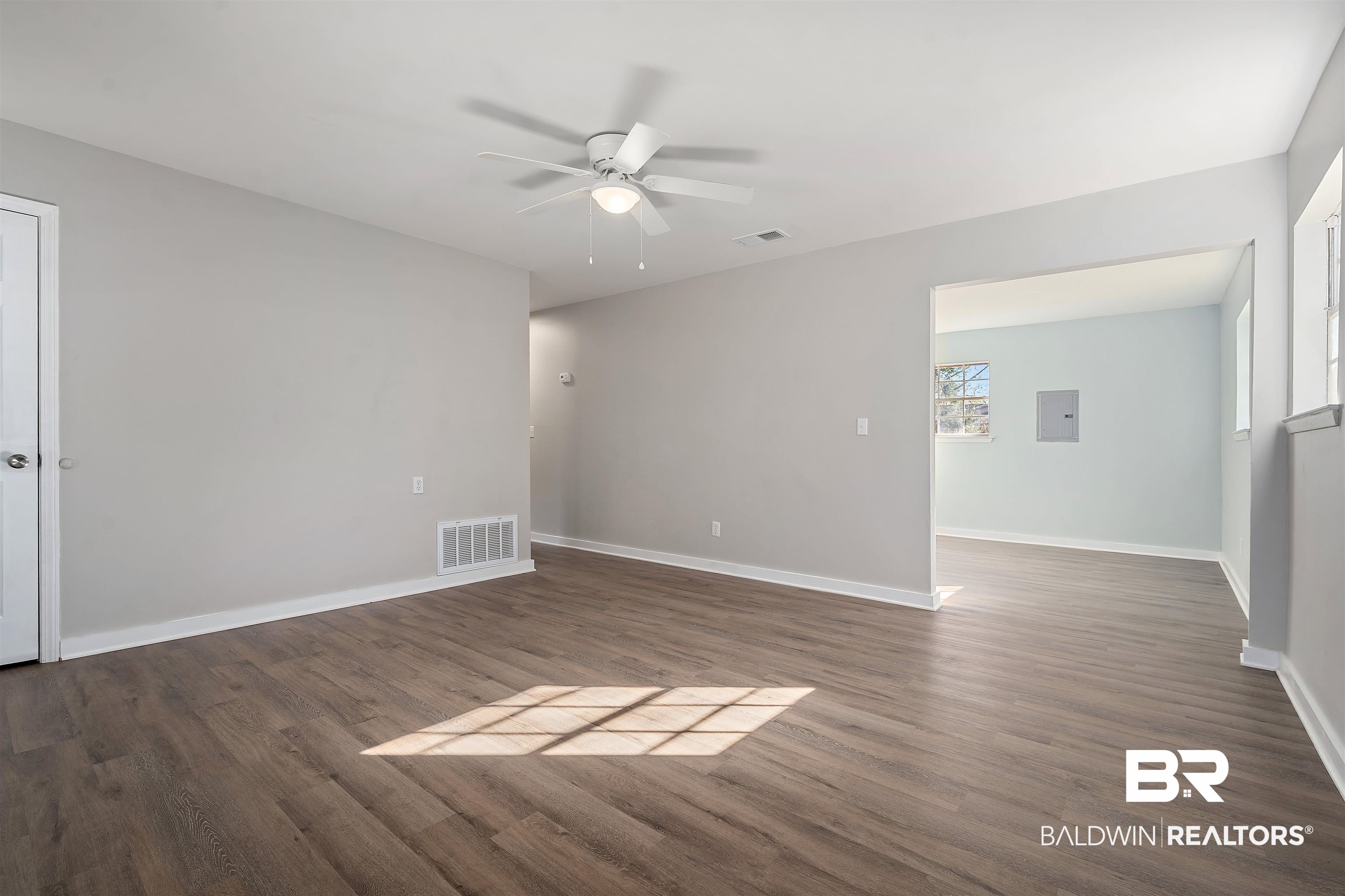 1368 Hubert Pierce Road Mobile, AL 36608 - Photo 5 of 25 Empty room with dark wood-type flooring and ceiling fan