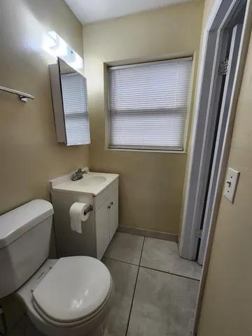 a white toilet sitting next to a bathroom sink