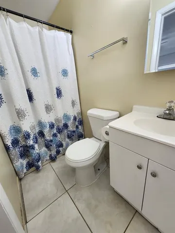a bathroom with a toilet sink and vanity