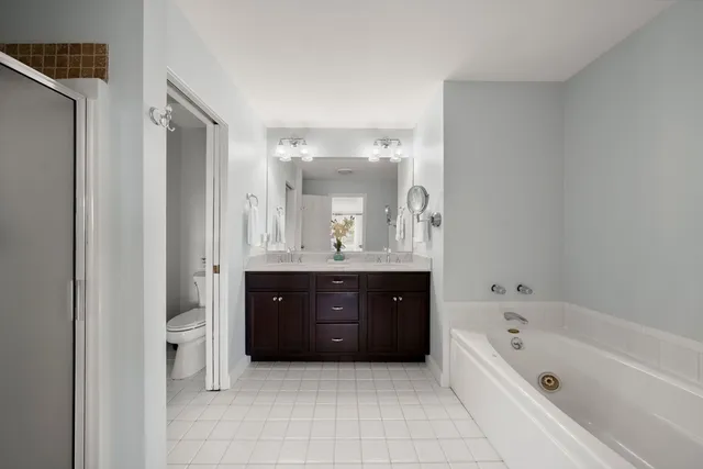 a bedroom with a bed and a mirror