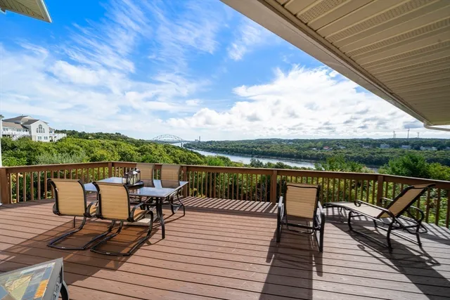a view of deck with furniture and city view