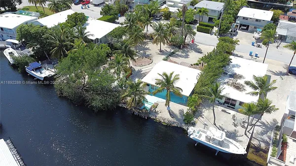 an aerial view of a house with yard swimming pool and outdoor seating