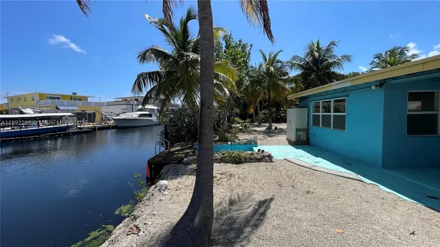 a backyard of a house with lake view and a potted plant