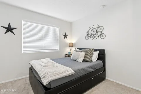 a bedroom with a bed and wall painting