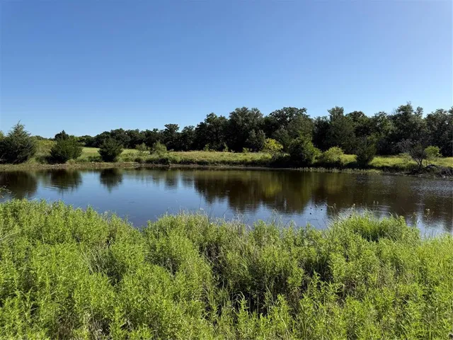 a view of a lake with houses in the back