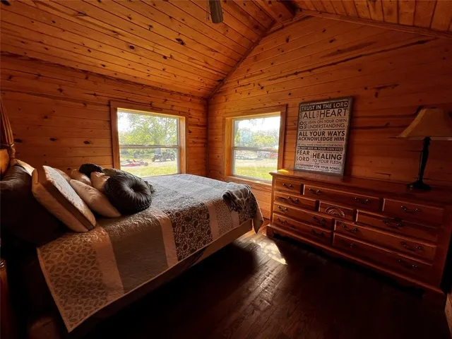 a bathroom with a granite countertop sink a toilet a mirror and shower