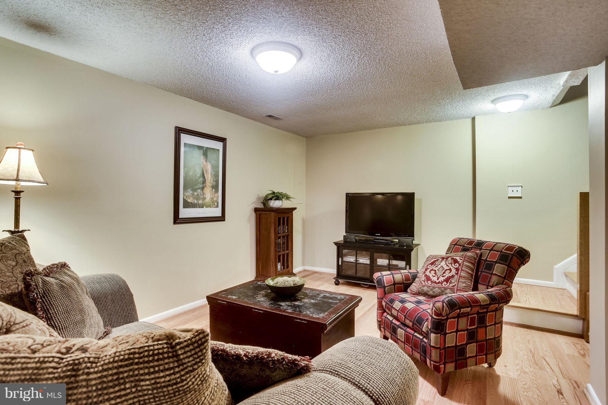 1447 Newport Spring Court Reston, VA 20194 - Photo 23 of 29 Finished Basement - hardwood floors