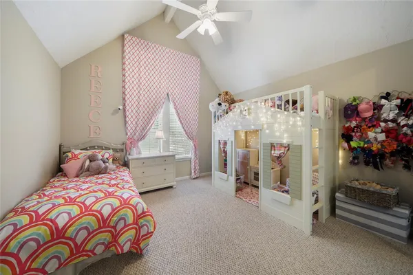 a bedroom with bed and a chandelier