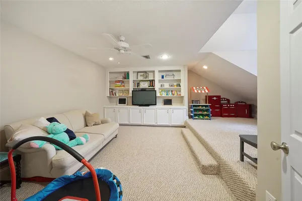 a living room with furniture and potted plant